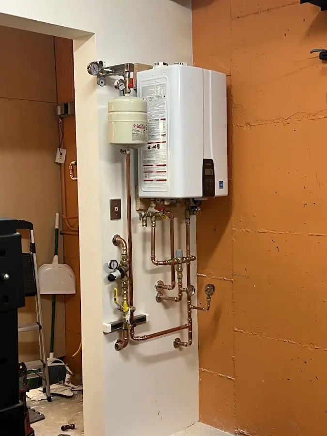 Plumbing technician inspecting water heater connections in Santa Cruz